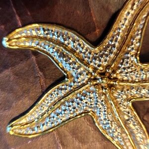 Handcrafted star pendant star fish in silver and gold plated metal.